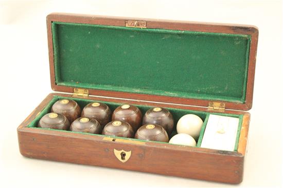 A mahogany cased set of indoor carpet bowls, 9.75in.